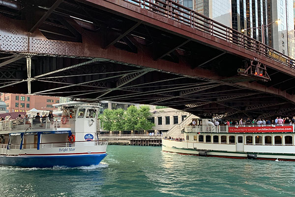 Boats passing under bridge on Chicago River