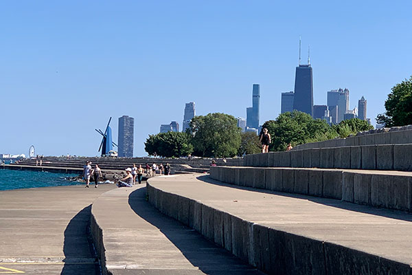 Cement walls along lake with city in background