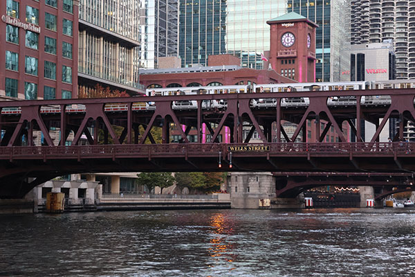 Train passes on elevated tracks over Riverwalk