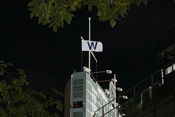 W flag on top of Wrigley Field scoreboard