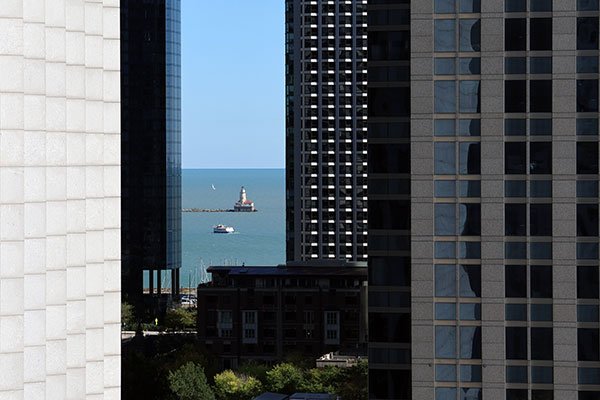 View of lighthouse between buildings