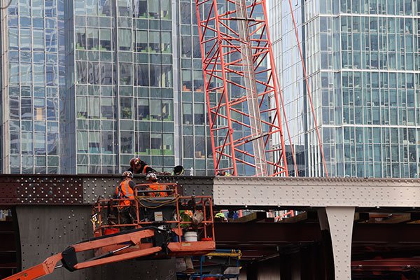 Construction workers working on brdge over South Branch of Chicago River