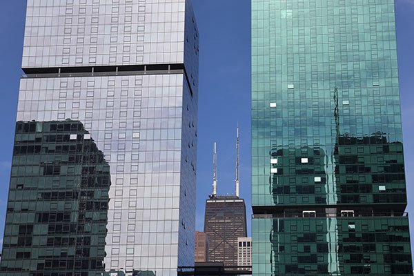 View of John Hancock Building between two building