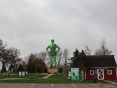 Jolly Green Giant Statue next to barn