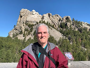 Pat smile in front of Mount Rushmore