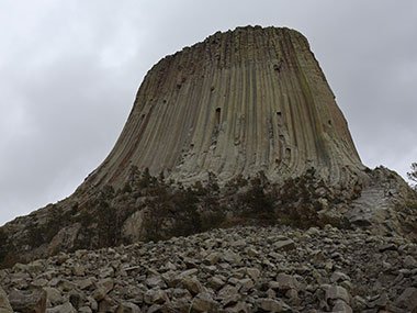 Devils Tower National Monument with dark clouds