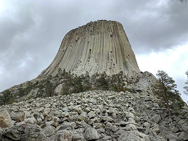 Devils Tower National Monument beyond rocks and trees