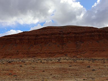 Red cliffs with clouds above