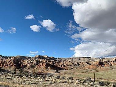 White clouds over hills