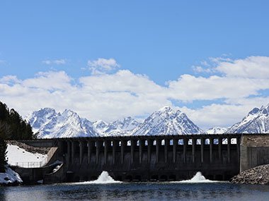 Dam at Grand Teton National Park with mountains beyond