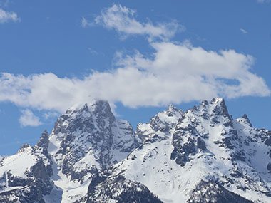 Grand Teton National Park mountains with clouds at peak
