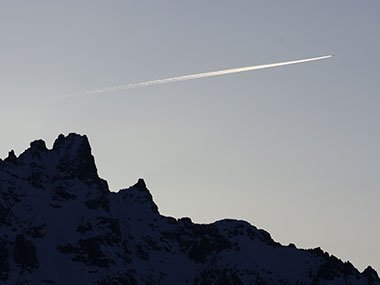 Grand Teton National Park mountain at sunset as plane flies over