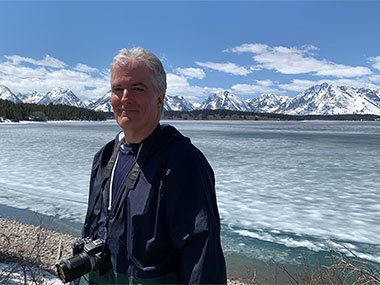 Pat in front of frozen lake at Grand Teton National Park
