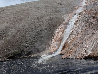 Water flowing into river from geyser basin