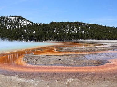 Red sediment with snow on hills beyond