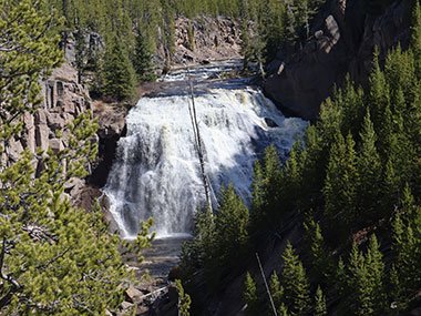 Yellowstone National Park waterfall in distance
