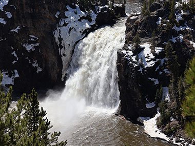 Yellowstone National Park waterfall splashes into river