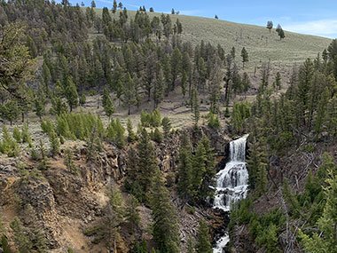 Yellowstone National Park waterfall in distance