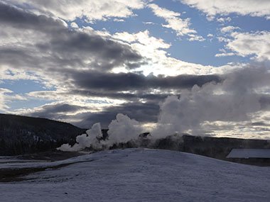 Steam rises from Old Faithful Geyser in Yellowstone National Park