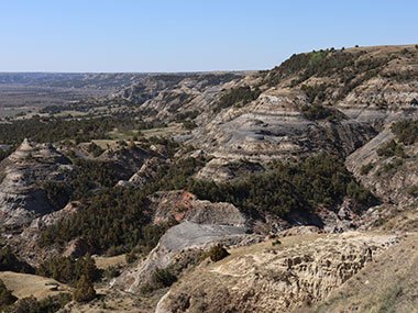 Theodore Roosevelt National Park Valley with blue sky beyond