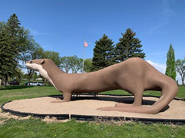 World's Largest Otter with flag behind