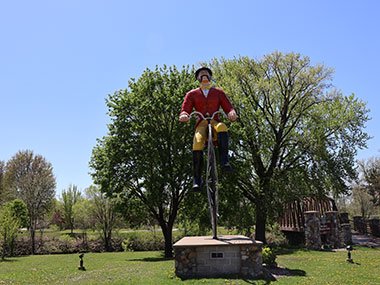 Trees behind World's Largest Bicyclist