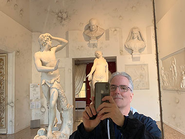 Selfie of Pat with statues in background