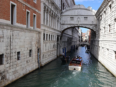 motor boat approaches the Bridge of Sighs