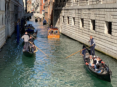 Gondolas pass on canal