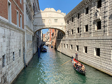 Gondola approaches after passing under the Bridge of Sighs