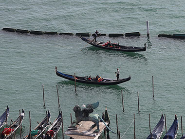 Two gondolas passing in open water