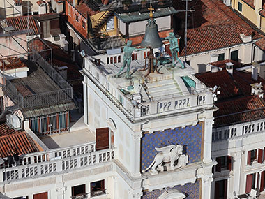 Two statues ringing a bell on clock tower