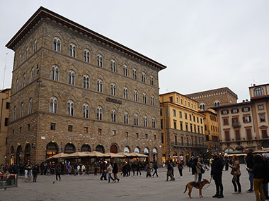 People walking a dog in Piazza della Signoria