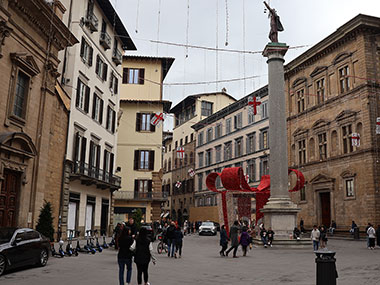 Statue with Christmas decoration behind it