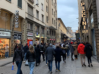 People walking in front of stores