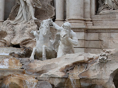 Closeup of statue of man and horse - Trevi Fountain