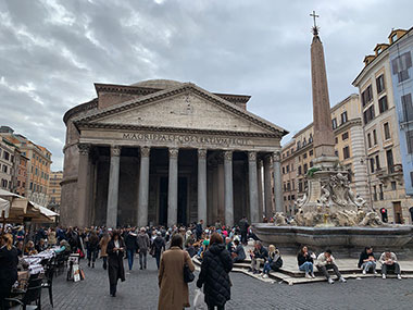 Pantheon with people sitting by fountain