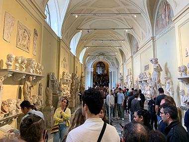 People walking halls of Vatican Museums