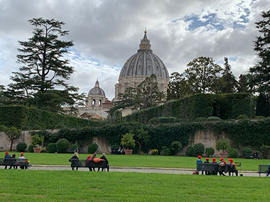 People on benches at Vatican Museums