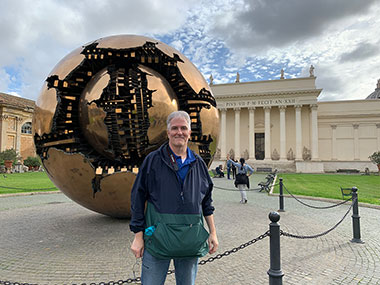 Pat in front of large metal sculpture at Vatican Museums