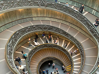 People walking on winding ramp at Vatican Museums