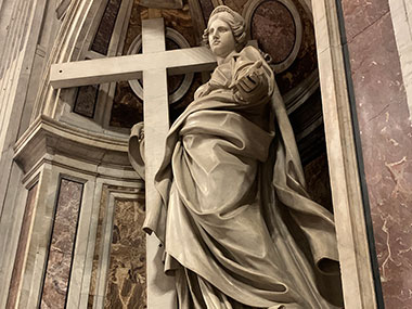 Statue of woman holding cross inside St. Peter's Basilica