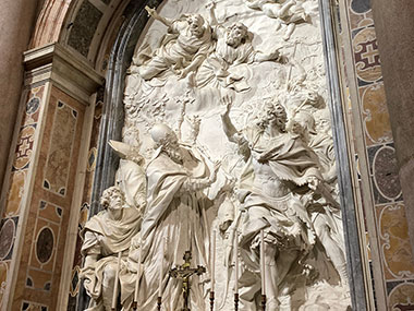 Statue of several people on the wall of St. Peter's Basilica