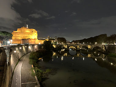 Building along river in Rome at night