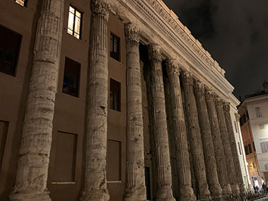 Columns of old building at night in Rome