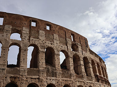 Clouds obscure the sky behind the Colosseum