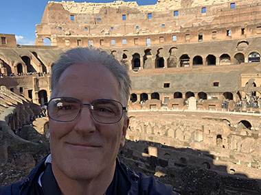 Pat in shade inside the Colosseum