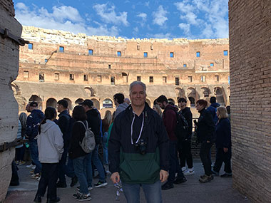 Pat with people behind him inside the Colosseum