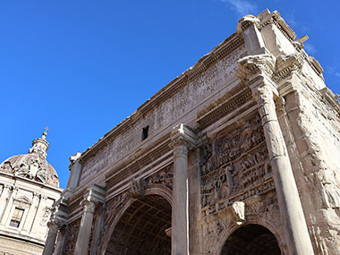 Arch with domed building to left in Roman Forum