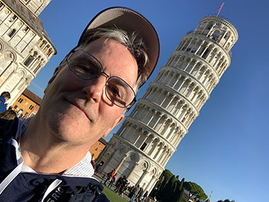 Pat in picture with Leaning Tower of Pisa on an angle